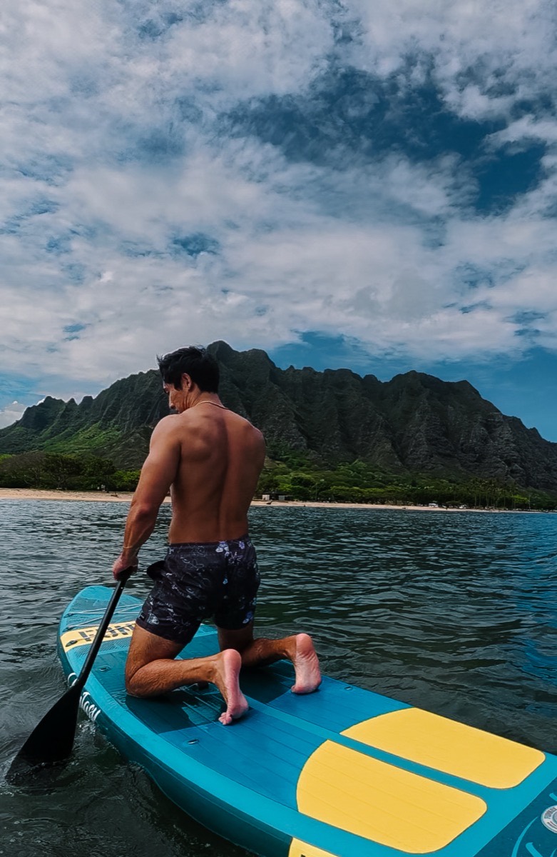 Nick paddling out on Kāneʻohe Bay, Koʻolau range behind